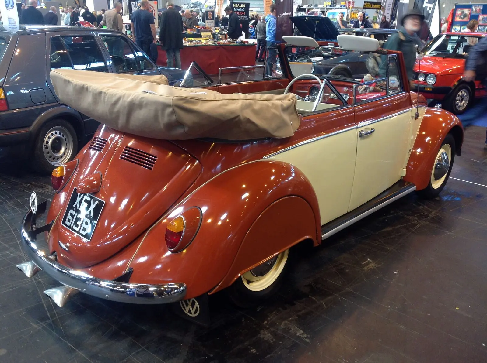 Two-tone orange and cream Volkswagen Beetle Karmann cabriolet at a car show